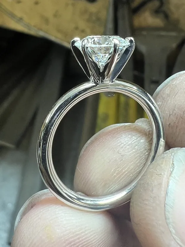 After: the same center stone reset in a new 14K solitaire setting built for a wedding band to sit flush