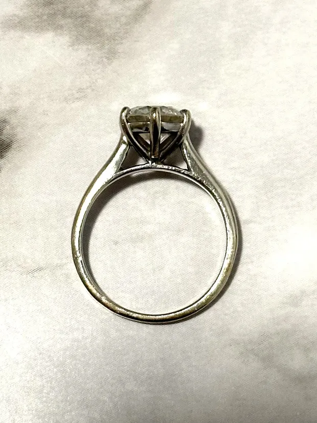 Before: the original solitaire engagement ring, set low with heavy prongs