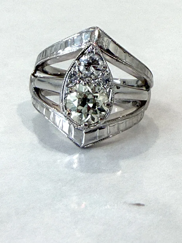 After: the same ring restored with the head lowered, prongs re-tipped and details re-engraved