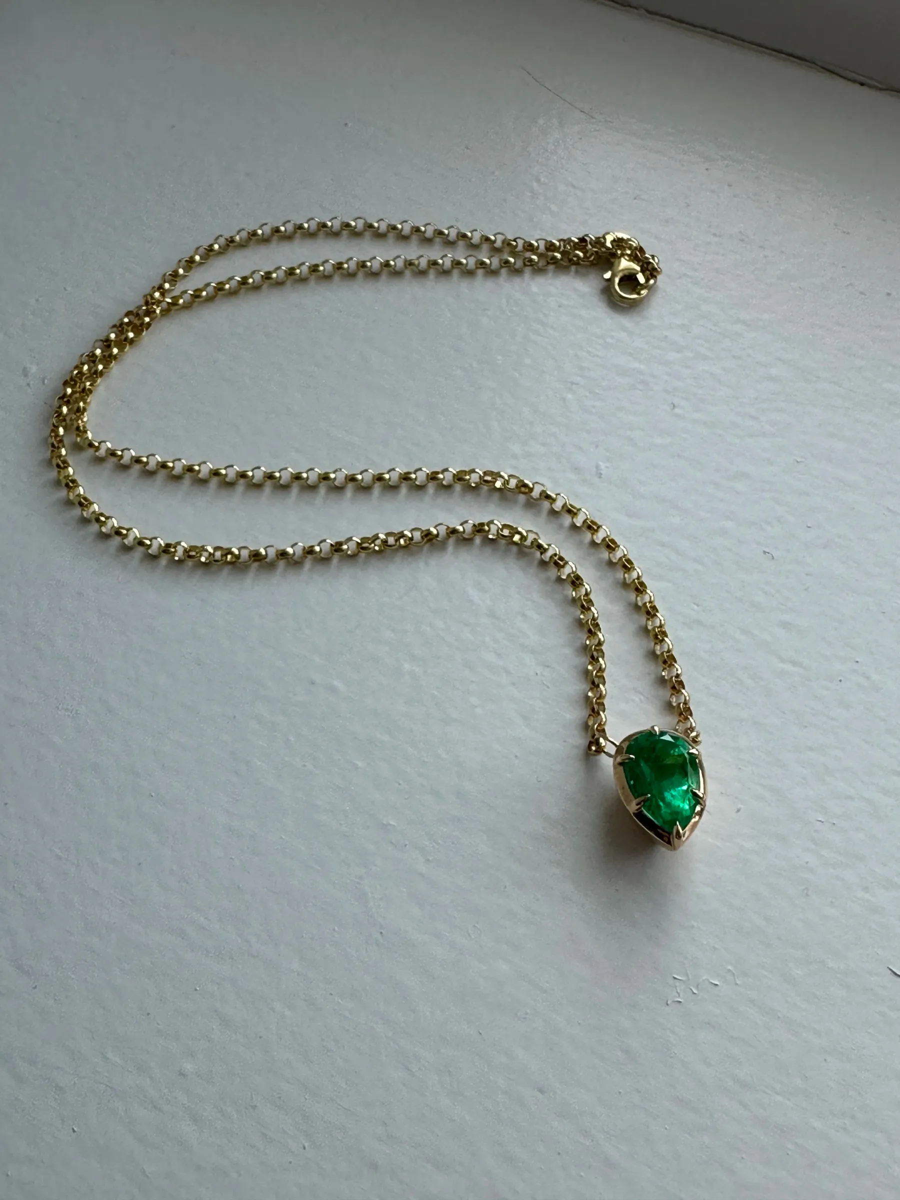 Finished custom Colombian emerald necklace with 18k yellow gold Victorian-style chain and claw prong setting, designed by A. D'Mae Diamonds Los Angeles